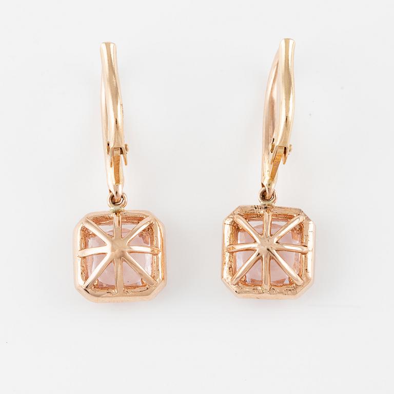 A pair of 14K gold earrings with faceted morganites and round brilliant-cut diamonds.