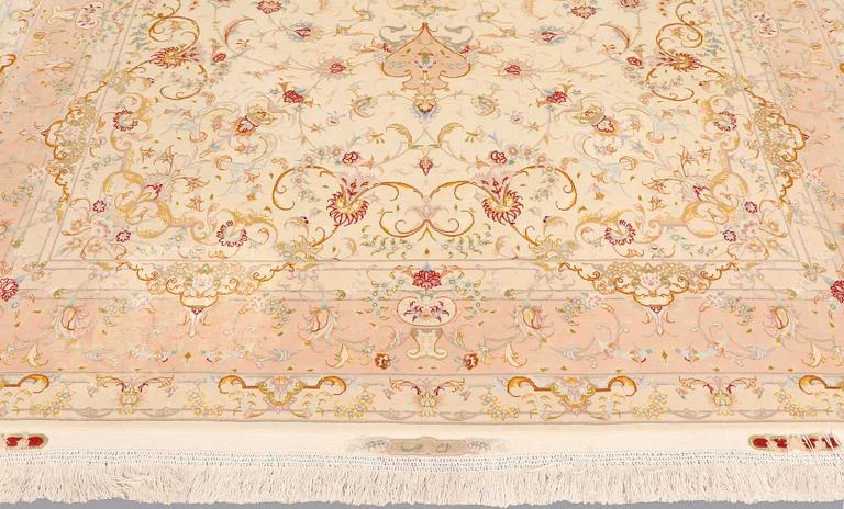 A Tabriz part silk carpet, signed, 305 x 203 cm.