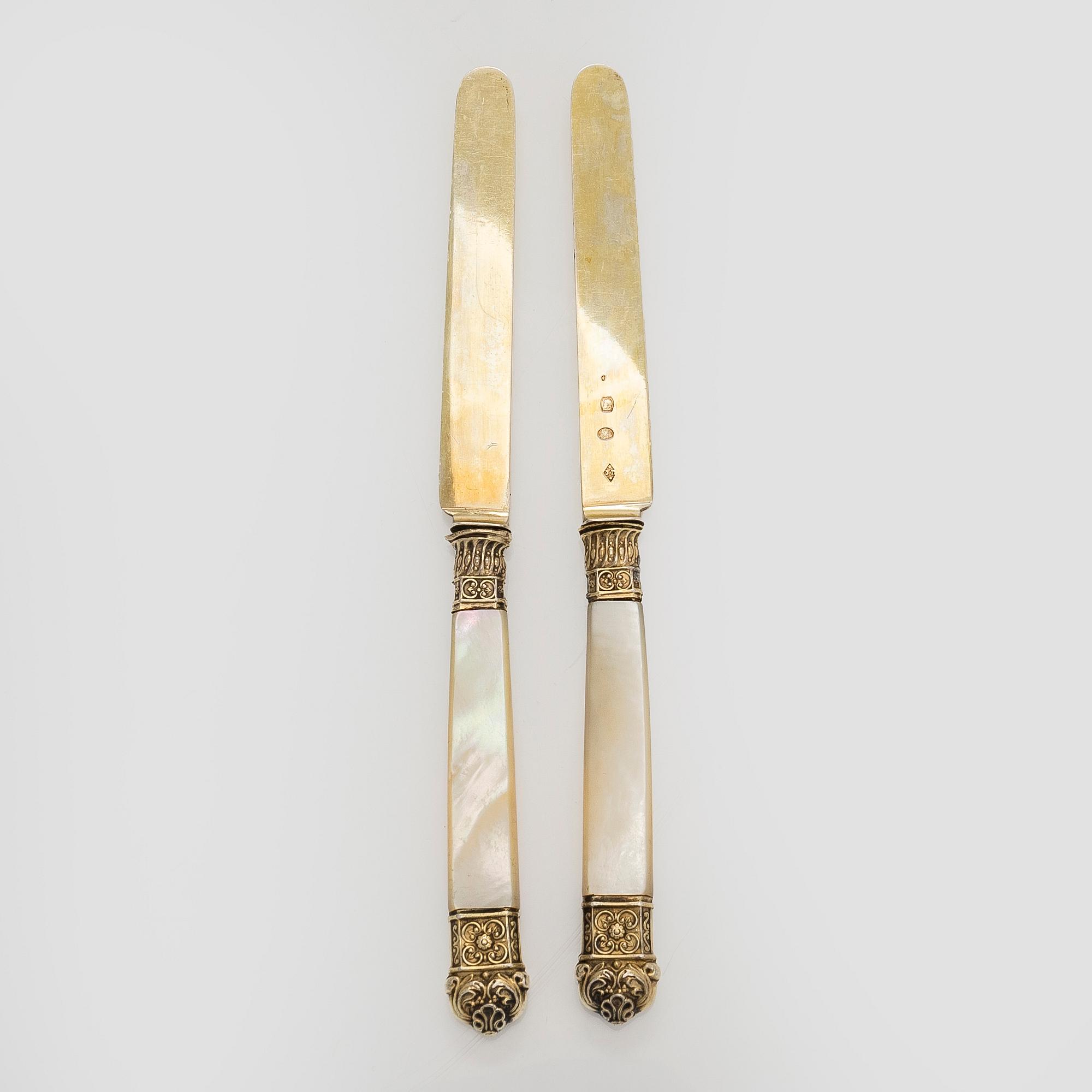 A set of eleven gilt silver dessert knives with mother-of-pearl stems, Paris 1819-1838.