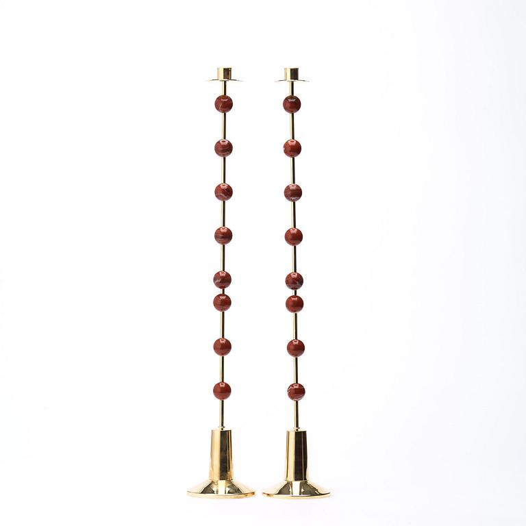 Sigurd Persson, A pair of brass and red jasper candlesticks, Uno Berg AB, Sweden.