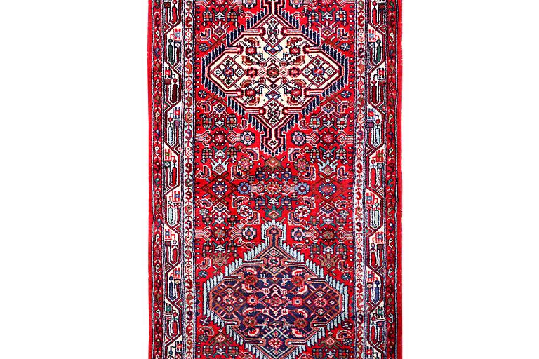 A Hamadan carpet, c. 304 x 84 cm.