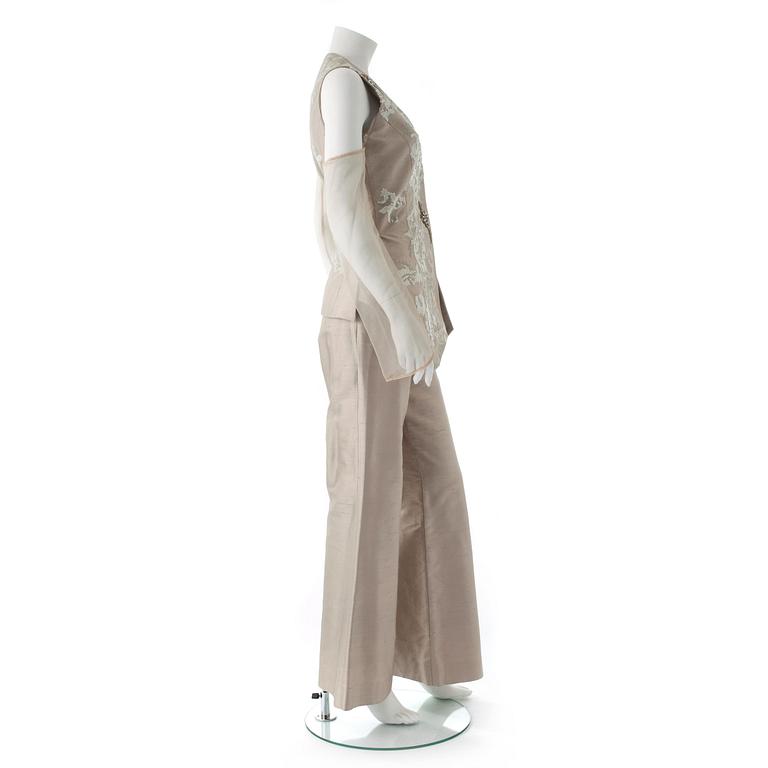 GIANFRANCO FERRÉ, a beige three-piece ensemble consisting of vest , trousers and skirt.