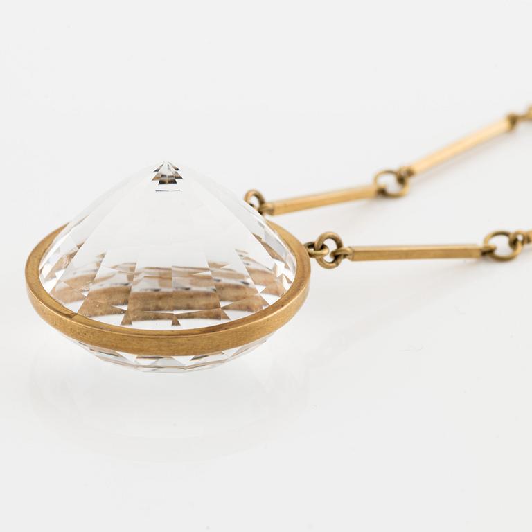 Wiwen Nilsson, an 18K gold necklace with a rock crystal pendant, Lund 1975.
