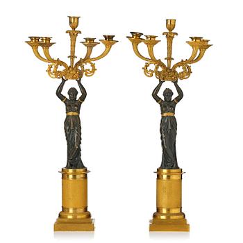 139. A pair of French Empire ormolu and patinated five-light candelabra attributed to F. Rabiat, early 19th century.