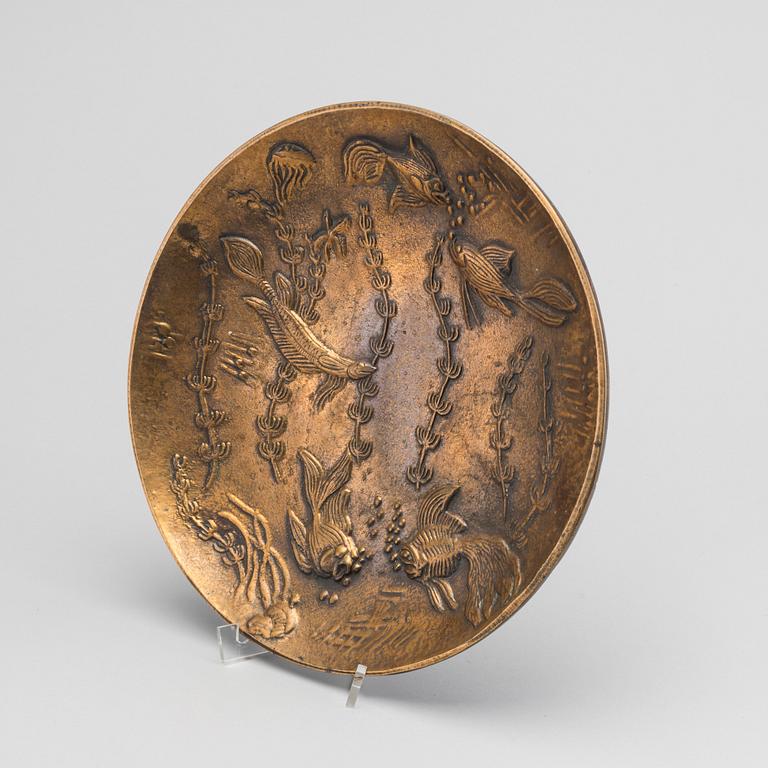 A GUNNAR NYLUND BRONZE PLATE.
