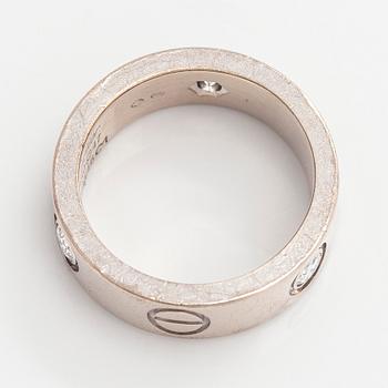 Cartier, an 18K white gold 'Love' ring with three brilliant-cut diamonds.