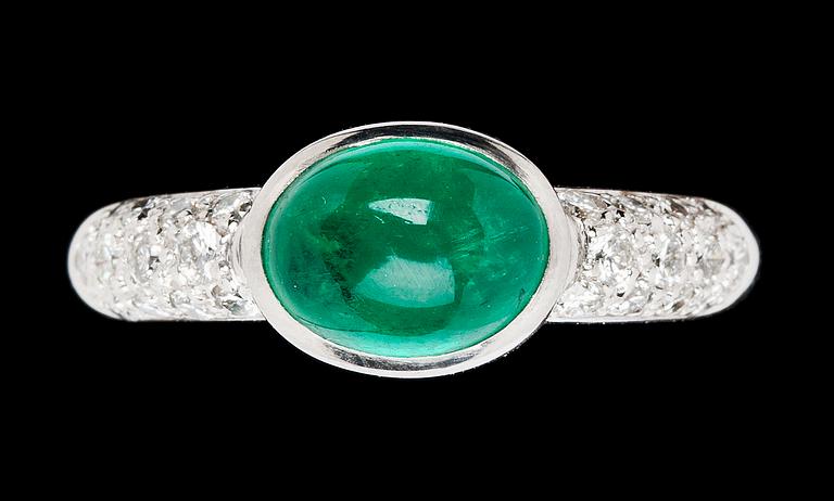 A cabochon cut emerald, 2.30 cts, and diamond ring.