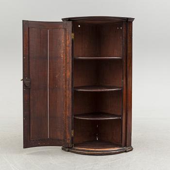 A 19th century corner cabinet.