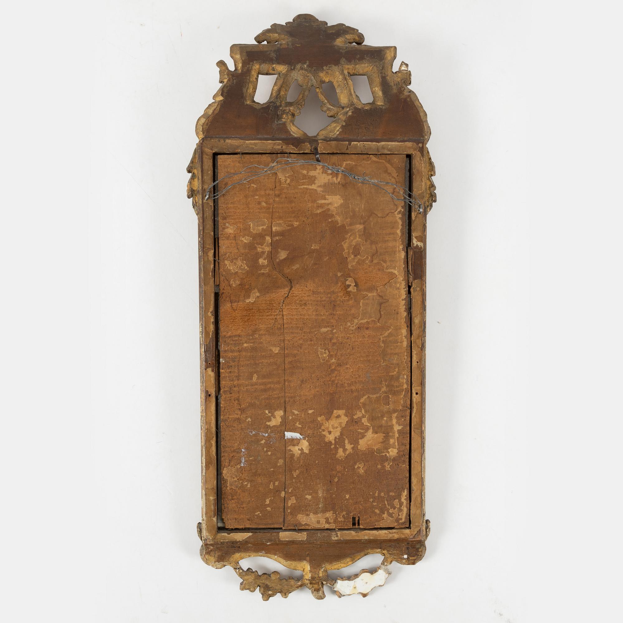 A Gustavian carved giltwood mirror, Stockholm, late 18th century.