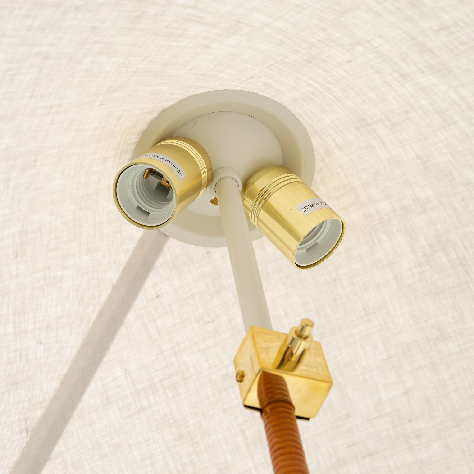 Paavo Tynell, A model 9602 brass and rattan floor lamp with canvas shade from Gubi,