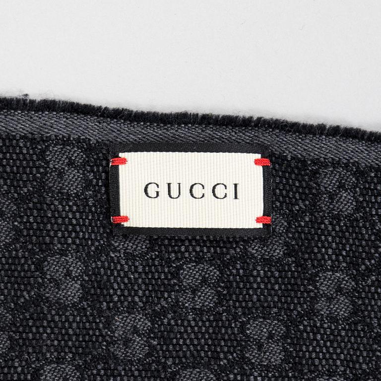 Gucci, A 'Verbier' scarf and a belt.