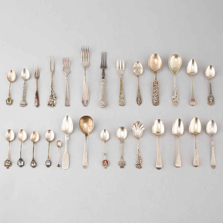 A collection of silver of 57 pcs, i.a souvenir spoons, 20th century. Total weight 1073 g.