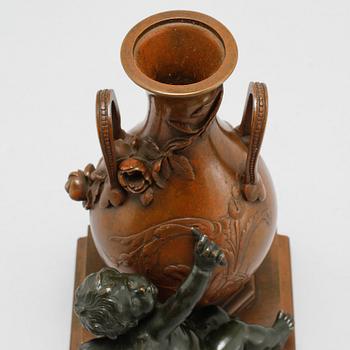 A patinated bronze vase after Auguste Moreau, made around year 1900.