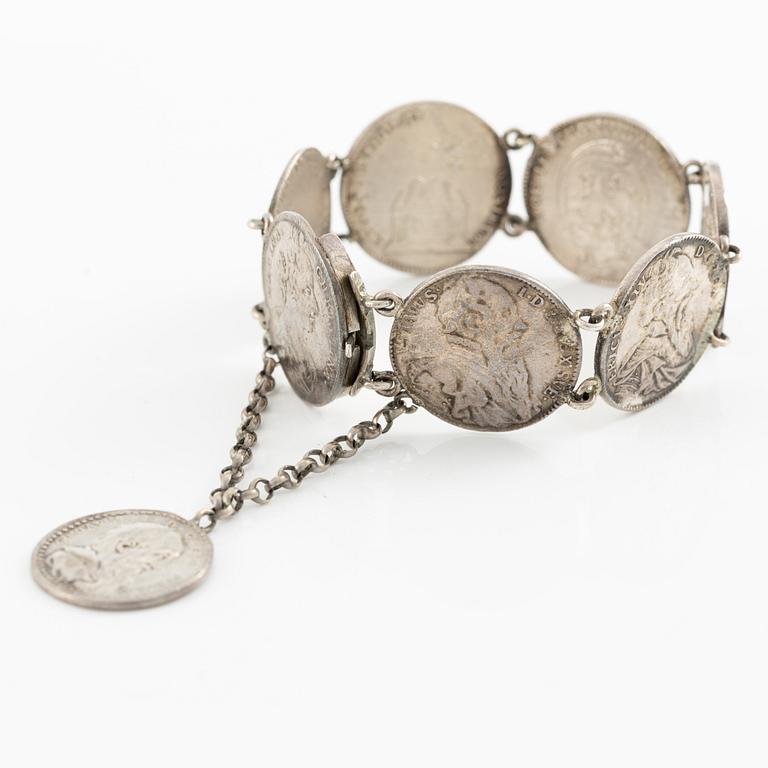 Two bracelets, a brooch, and a pendant with coins.