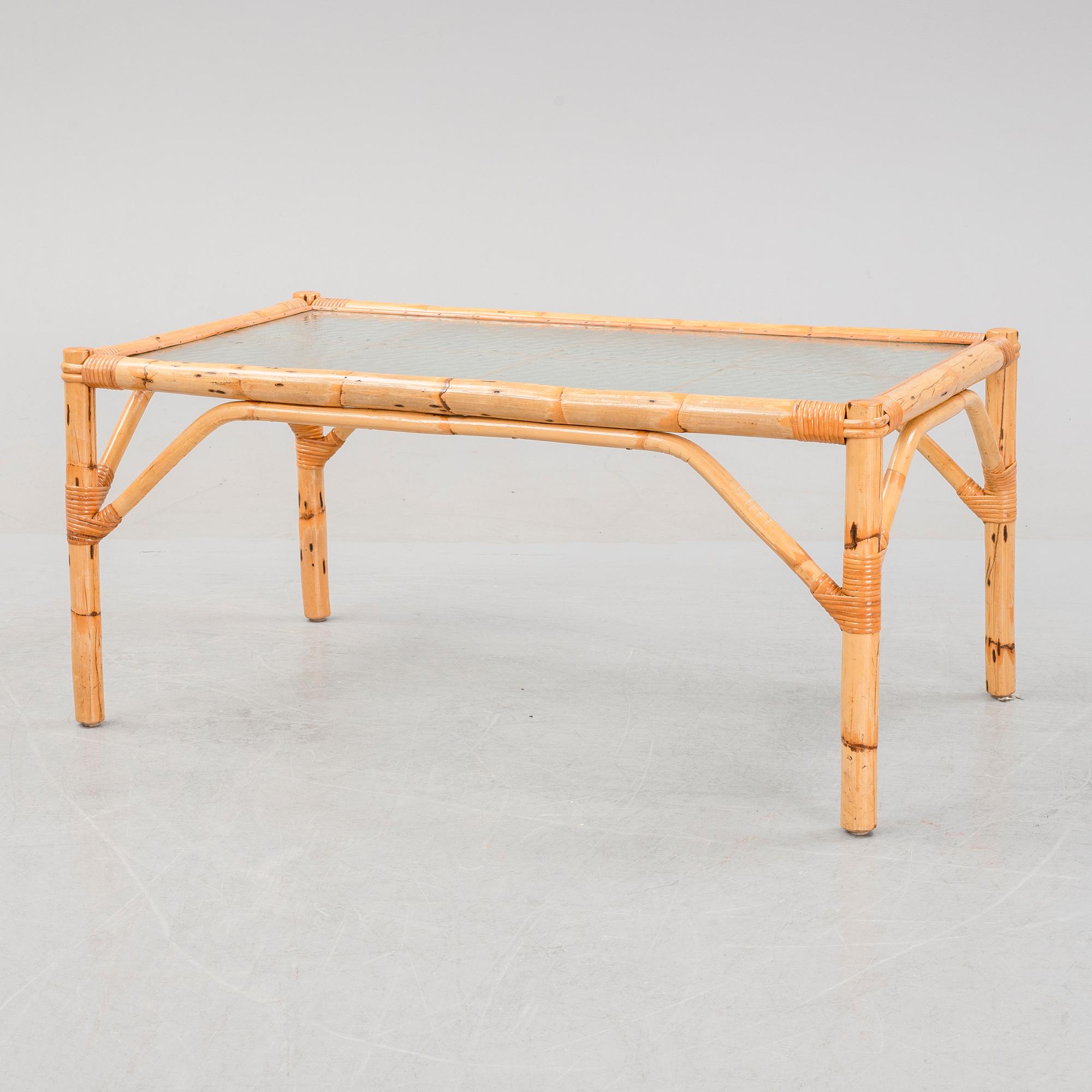 A set of two garden sofas, an armchair and a glass table, later part of the 20th Century.