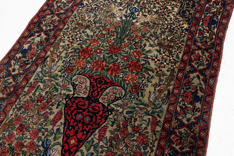 A figural oriental rug, c.. 230 x 130 cm.