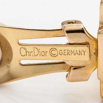 Christian Dior, A pair of gold coloured metal earrings with rhinestones. Marked Chr. Dior, Germany.
