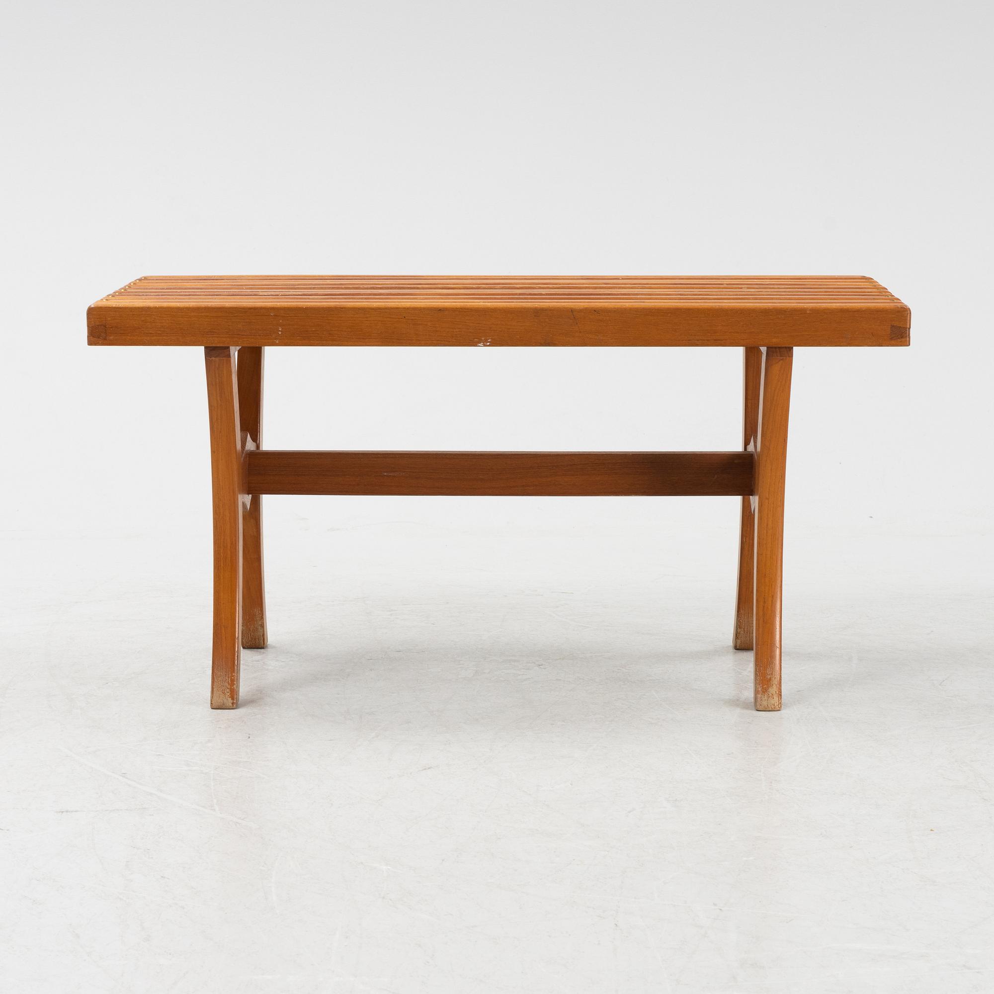 A stained-wood bench, later part of the 20th Century.