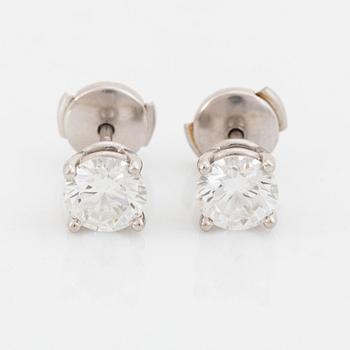 402A. A pair of Tiffany solitaire diamond stud earrings in platinum.