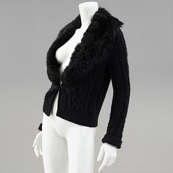 A black knitted cashmere cardiganwith fur collar by Ralph Lauren.