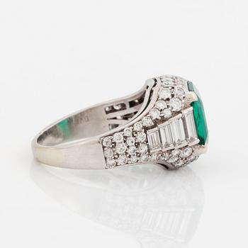 A Bulgari "Trombino" ring in platinum set with a step-cut emerald and round brilliant- and baguette-cut diamonds.