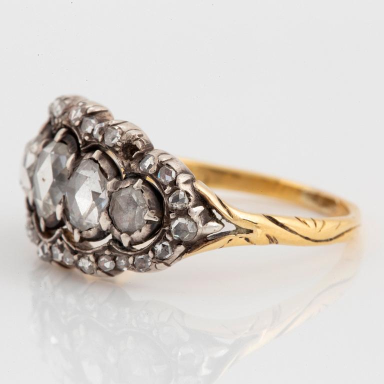 An 18K gold and silver ring set with rose-cut diamonds.