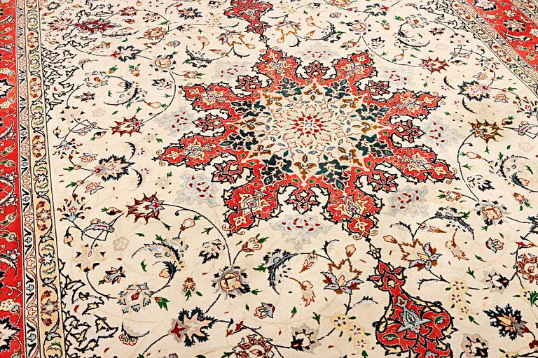A Tabriz, part silk carpet, c. 300 x 199 cm.