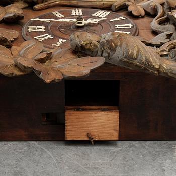 A Black Forest area pendulum wall clock.