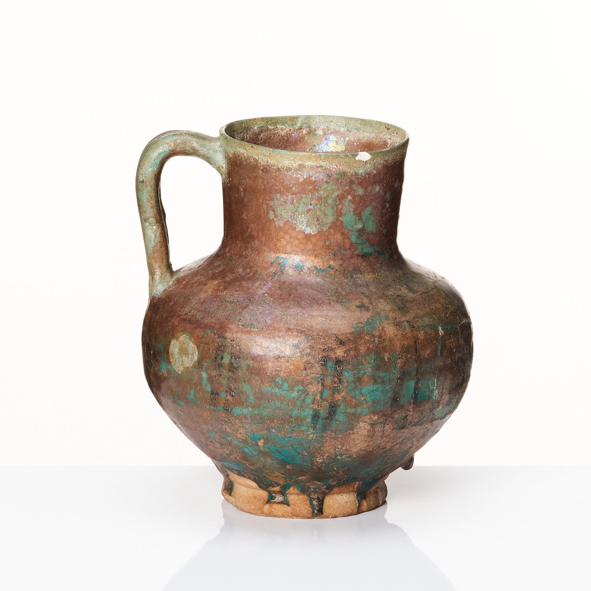 A 12-13th century turquoise and black underglazed jug.