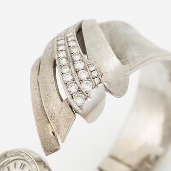 Aftonklocka/armring, Bo Dolk, 18K vitguld med briljantslipade diamanter, 1970-tal.
