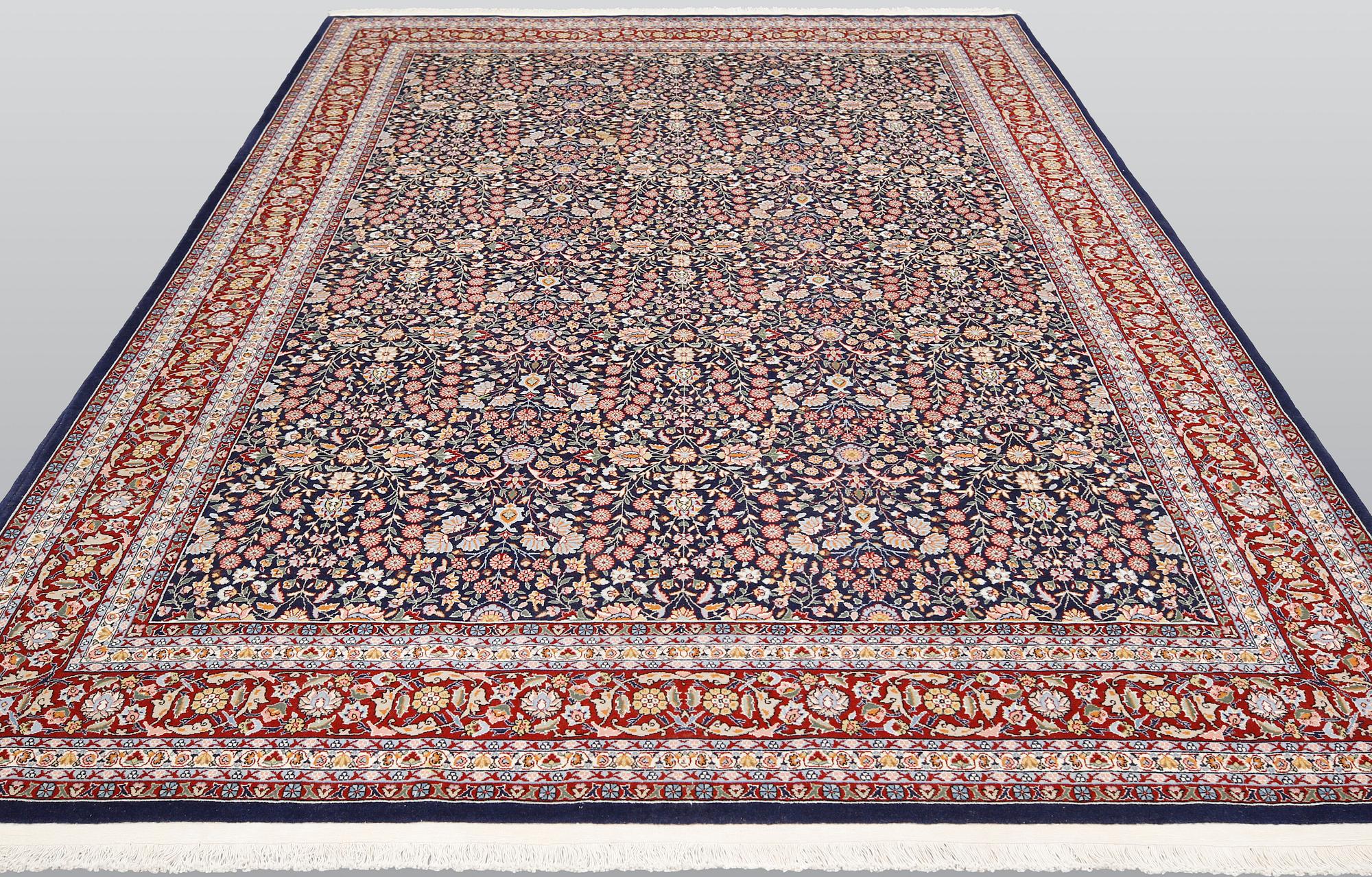 A signed Hereke carpet, ca 340 x 246 cm.
