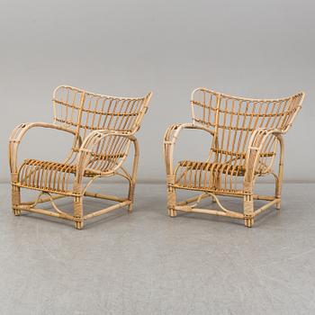 A pair of mid 20th century rattan easy chairs.