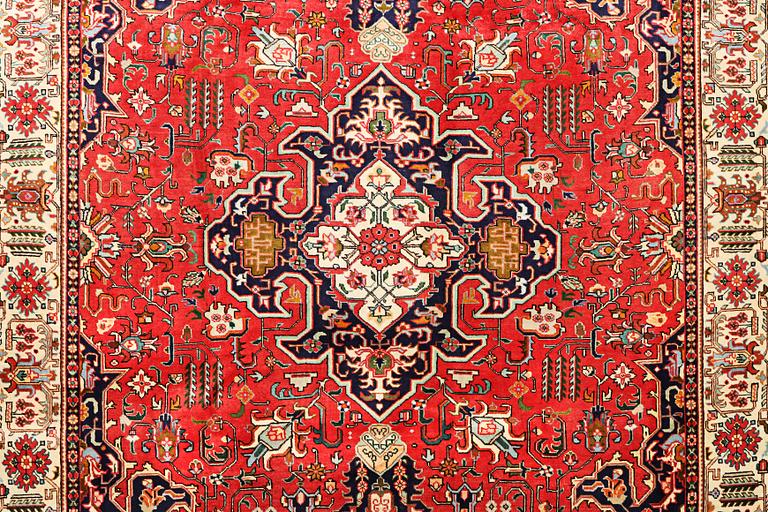 A Tabriz carpet, c. 335 x 257 cm.
