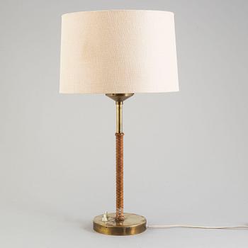 A brass and leather table light from Nordiska Kompaniet, mid 20th Century.