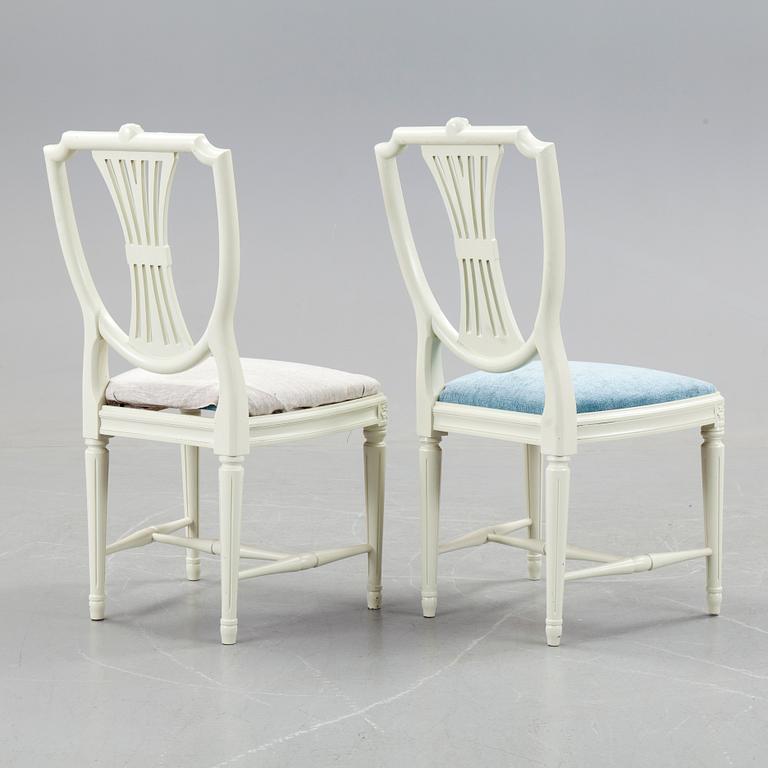 A set of a dozen white gustavian style chairs, second half of 20th century.