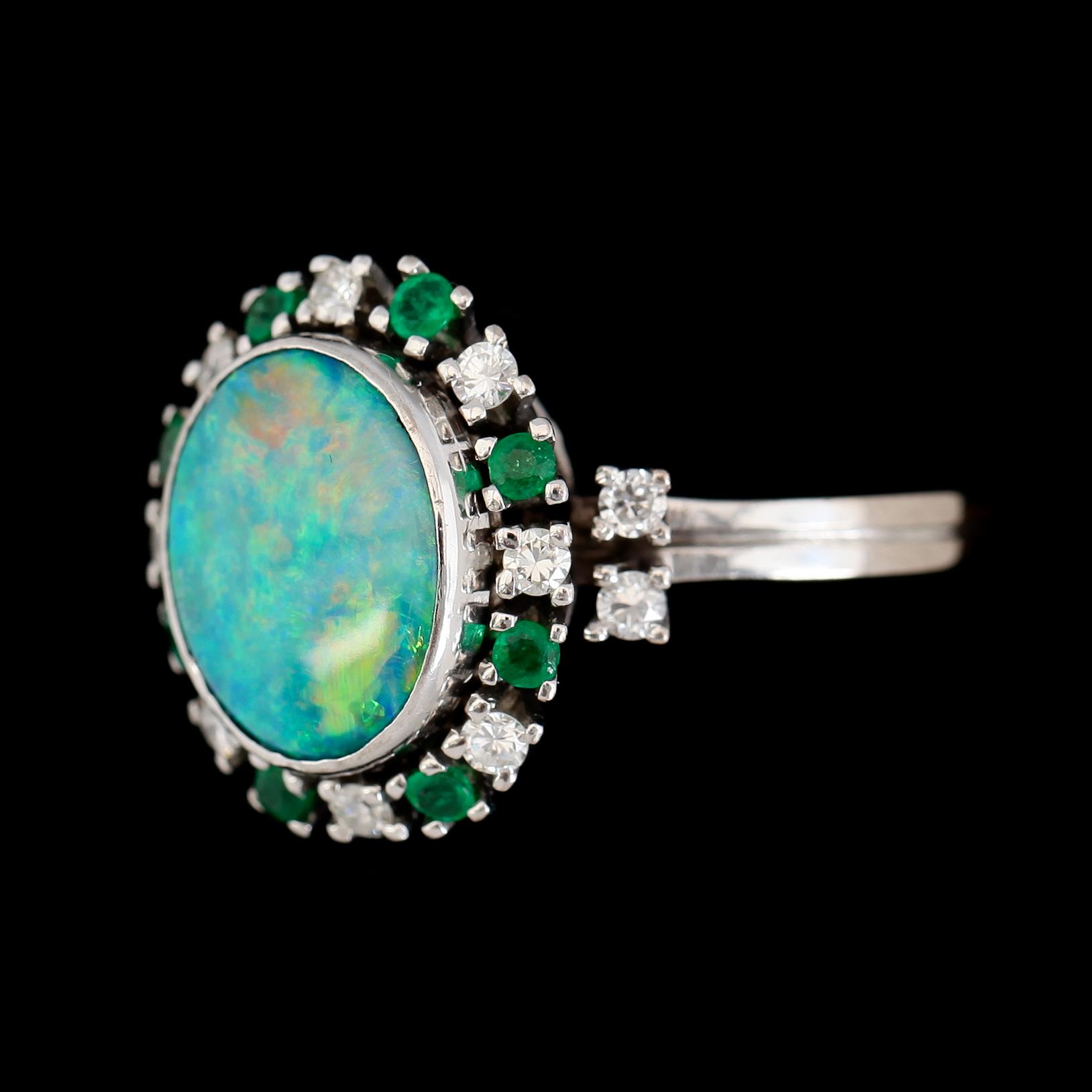 RING, 18K vitguld, opal, briljantslipade diamanter och smaragder.