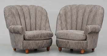 A pair of Carl Malmsten 'Redet' (The Nest) easy chairs with ottomans,
