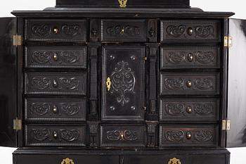 A South-German Baroque ebonized collector's cabinet on stand, circa 1700.