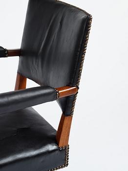 Josef Frank, a mahogany and black leather swivel chair, modified version of model 695, Svenskt Tenn, ca 1956-1957.