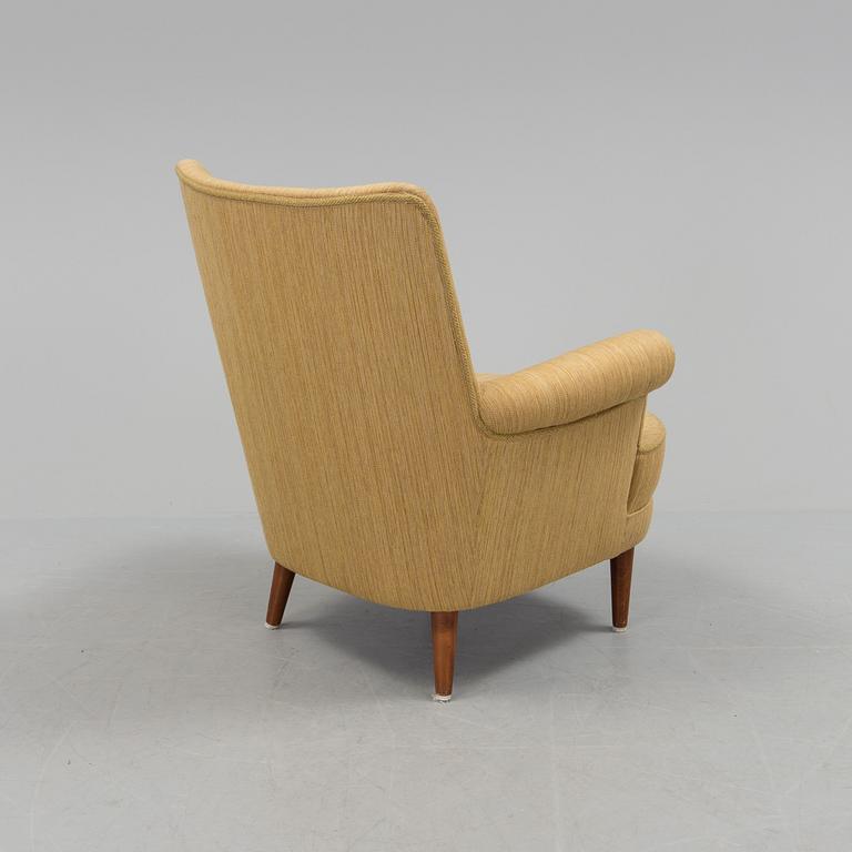 A mid 20th century armchair "Hemmakväll" designed by Carl Malmsten .