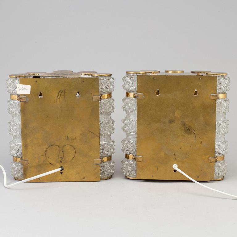 A pair of 1970's glass and brass wall lamps.