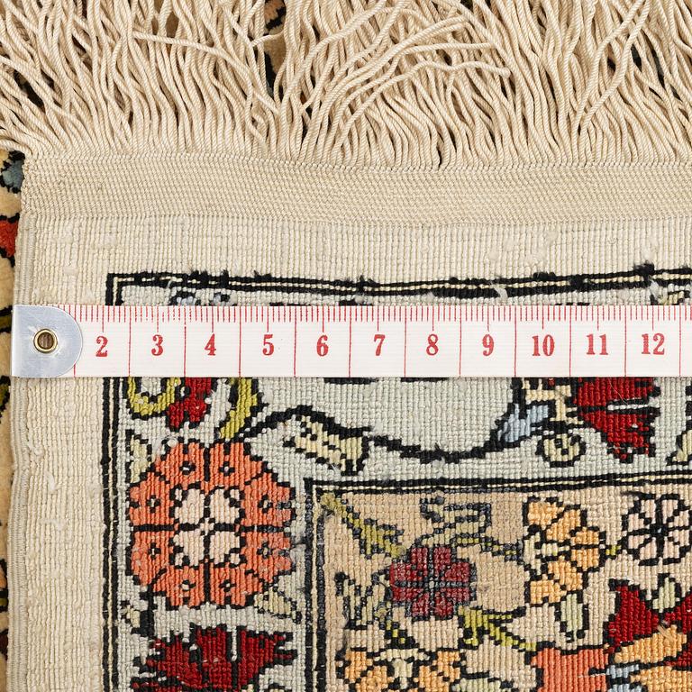 A semi-antique silk Hereke rug, c. 155 x 103 cm.