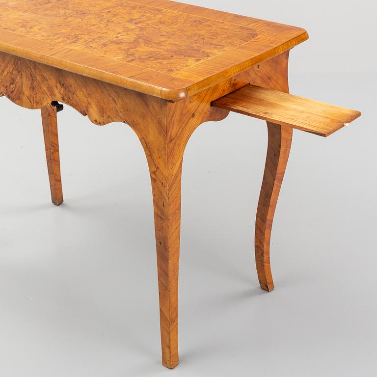 An elm veneered Rococo games table, 18th Century.