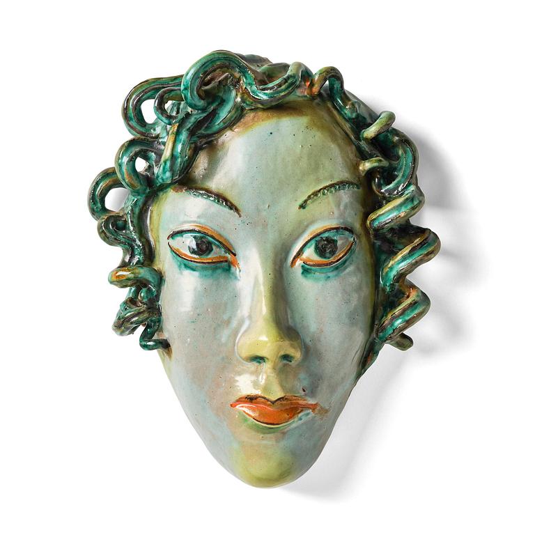 Allan Ebeling, a glazed earthenware wall sculpture of a masque, Torshälla 1934.