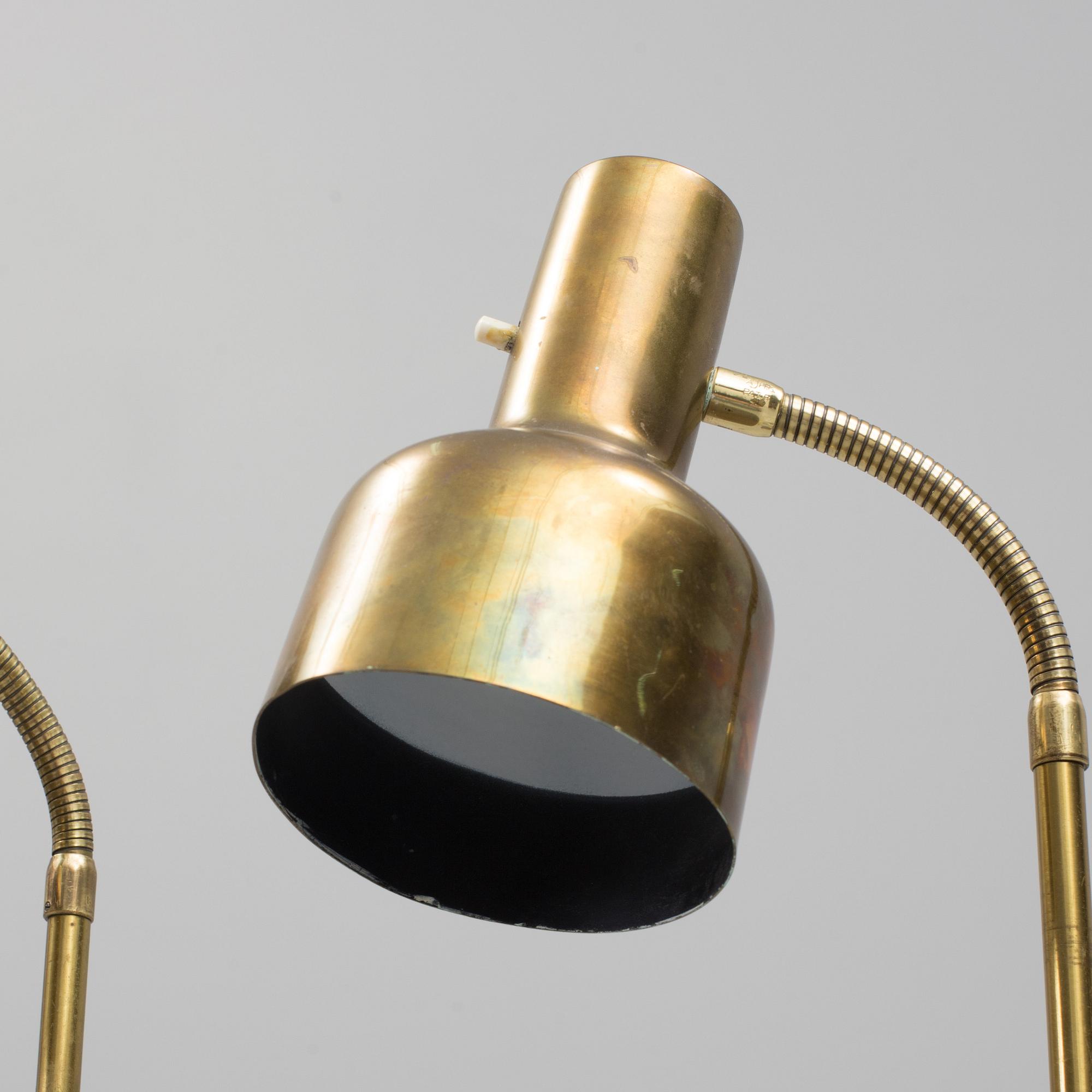A pair of brass floor lamps, "MAE 27".