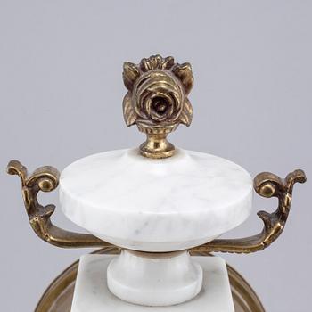 A French mantlepiece clock and a pair of candelabras, first half of the 20th century.