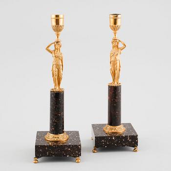 A pair of late gustavian early 19th century porphyry and ormolu candlesticks.