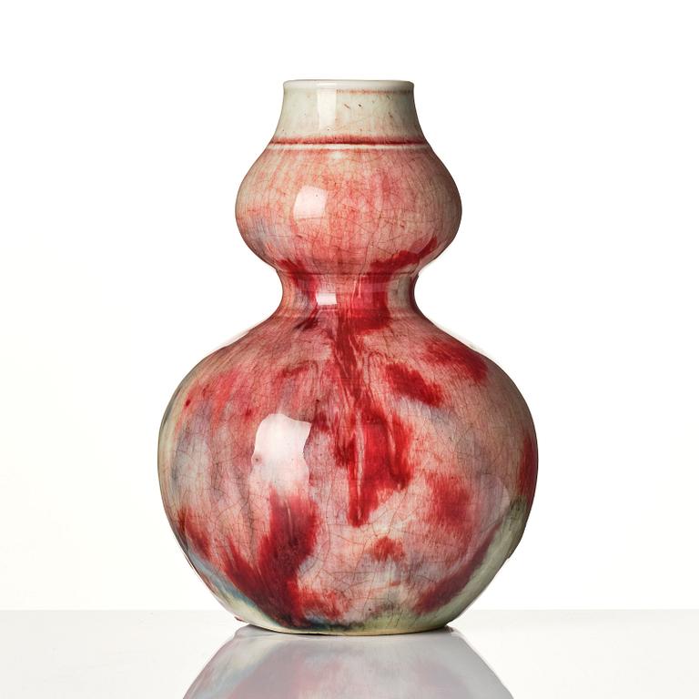 A Chinese peach bloom double gourd vase, Qing dynasty.