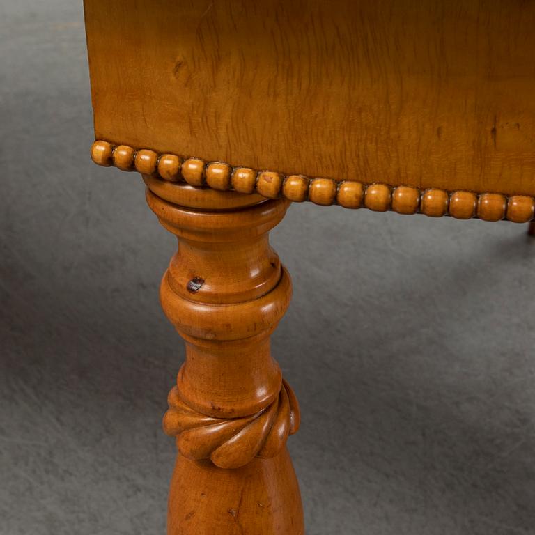 A mid 19th century birch dining table.