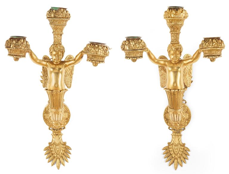 A pair of Empire early 19th century three-light wall-lights.